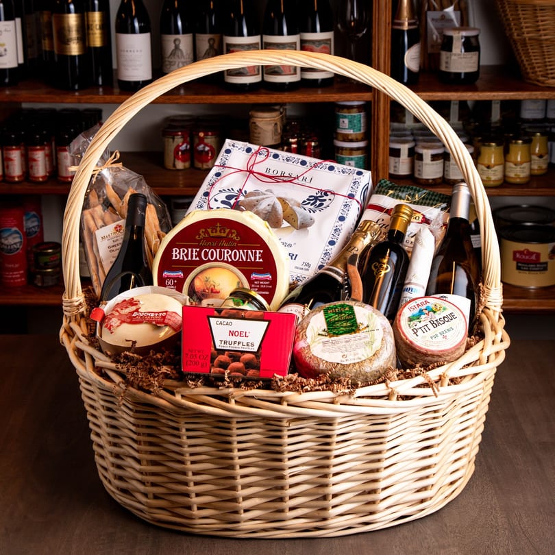 A large wicker gift basket from The Cheese Store of Beverly Hills filled with gourmet deli items.